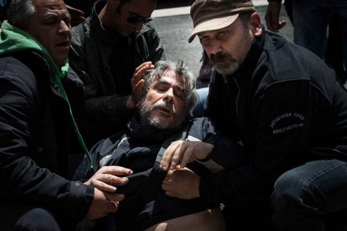 Rome, Italy, 16/4/2014.Several people have been injured in Rome as clashes erupted while Italian police evicted 350 squatter families caught up in the country's economic crisis. 350 families are locked on the roof of an occupied building.Riot police get ready to drag away some 350 squatter families from abandoned offices in Rome